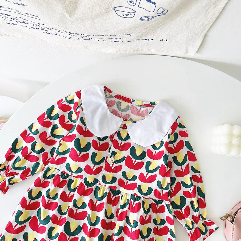 Close-up of the red floral 'Mariella' Floral Print Peter Pan Collar Dress, featuring button details and stylish lantern sleeves.