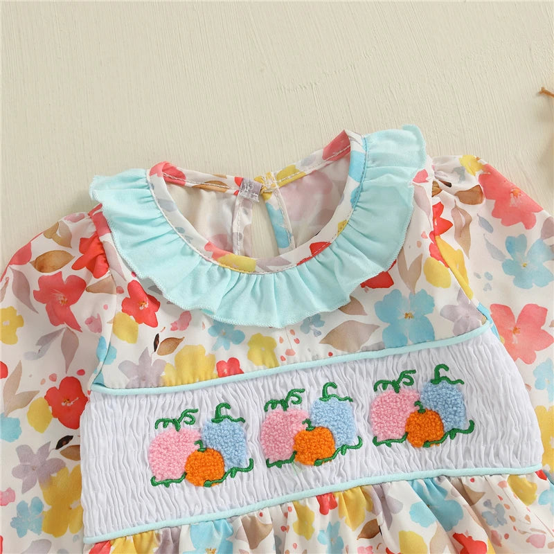 Close-up of the Fall Fabulous Pumpkin Embroidered Bubble romper's embroidered pumpkins and ruffled collar, highlighting its adorable autumn theme.