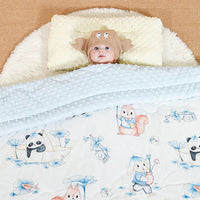 Baby on a quilted 120 x 150 cm nap blanket with raised dots and panda, whale, bear, elephant, rabbit prints.