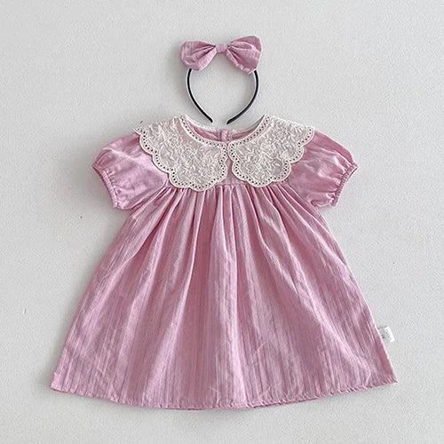 Lovely pink Vintage Outfit dress for toddlers with a lace-trimmed collar and matching bow headband.