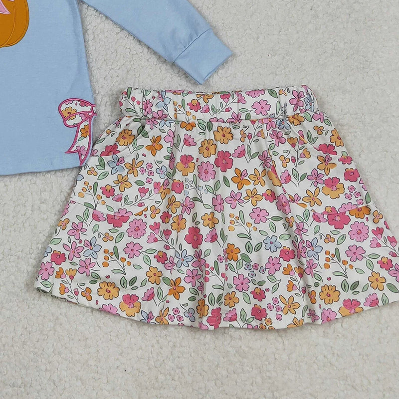 Close-up view of the floral-printed skort and Newport blue top in the Pumpkin Fleurs Baby Girls' Embroidered Skort Outfit, illustrating the playful design.