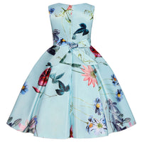 Little girls tropical garden party dress in blue floral print with waist bow and full pleated mid-calf skirt.