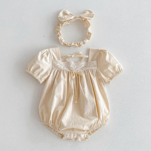 Vintage Outfits for toddlers showcasing a beige romper with lace accents and a matching headband from The Palm Beach Baby.