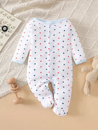 Footed baby romper with red and navy stars on white cotton, light blue trim; part of an 8-piece layette set