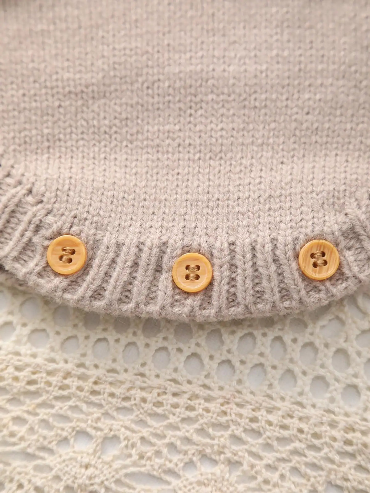 Beary Cute khaki knitted fabric with tan buttons along ribbed hem.