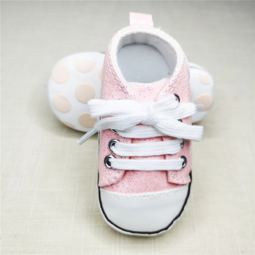 Baby's Canvas Soft Sole Lace-up First Walkers in Shimmering Pink, perfect first shoes for tiny feet taking their first steps.