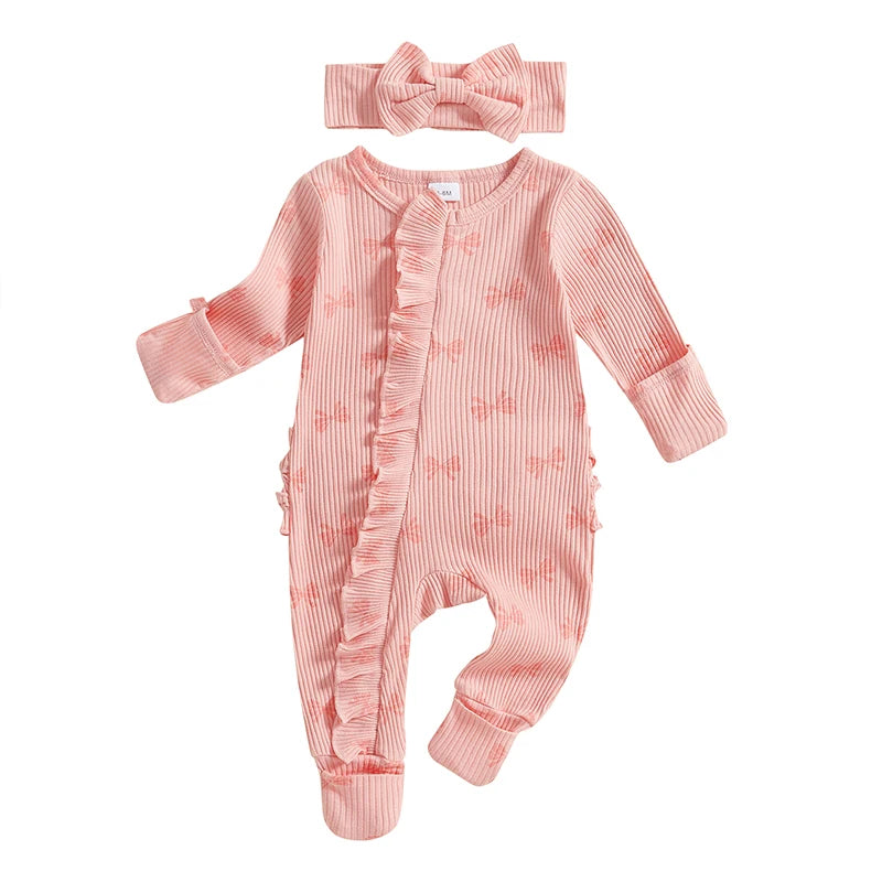 "Bow-tique" Baby Romper Set in pink with subtle floral pattern and matching headband, designed for comfort with soft fabric and a cozy fit.