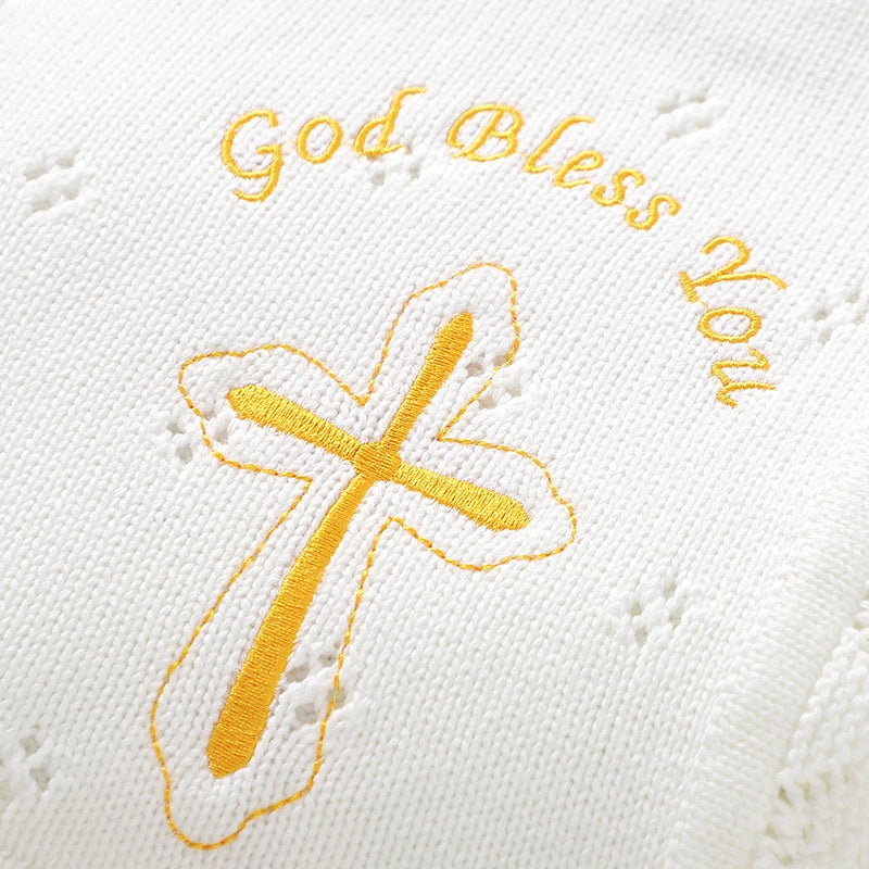 White cotton knit baby baptism blanket with a gold cross and 'God Bless You' embroidery.