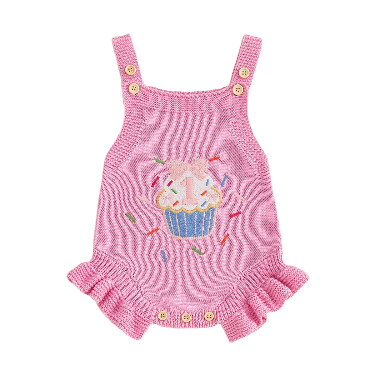 Pink knitted baby romper overalls with cupcake embroidery, frilly hem, and buttoned leg openings.