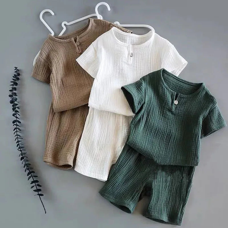 Lightweight Children's Cotton Linen Shorts Set featuring two earthy tones along with a white top, ideal for playful summer days.