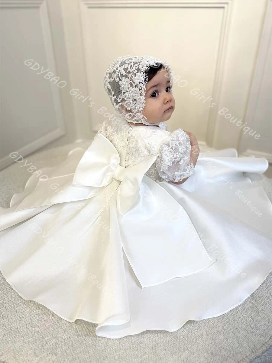 Hannah White beaded lace flower girl gown with matching bonnet, full satin skirt and bow.