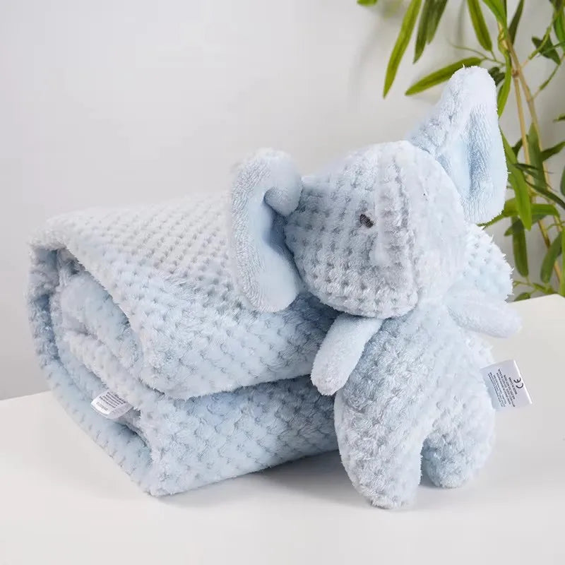 Light blue waffle-knit baby blanket with an attached plush elephant doll.