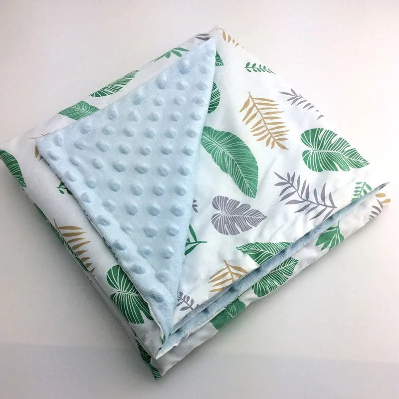 Colorful leaf-printed Dotted Minky blanket with a light blue dotted reverse, 100x75 cm.