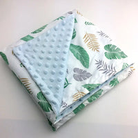 Colorful leaf-printed Dotted Minky blanket with a light blue dotted reverse, 100x75 cm.