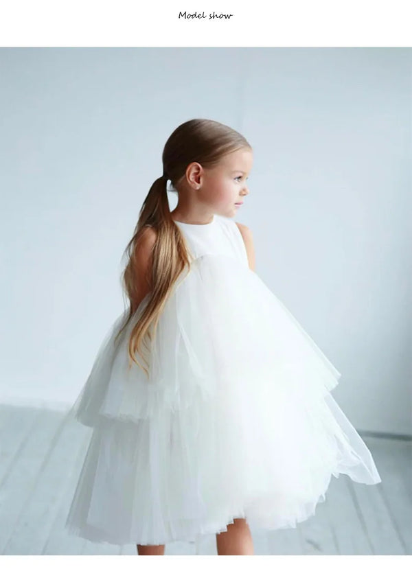 White Cara Ann girls tiered tulle party dress with empire waist and round neckline, mid-calf length.