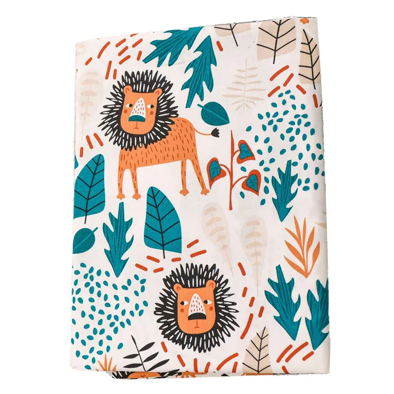 Soft baby blanket featuring playful orange lion and teal leaf print. Ultra-soft minky fabric, 100x75cm, perfect for nursery or gifting.
