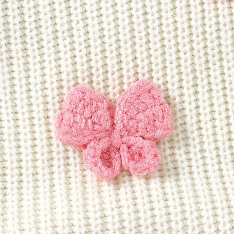 Detailed crochet bow accent on the Little Bow Peep Crocheted Knit Baby Romper, showcasing the charming design of this knit baby outfit.