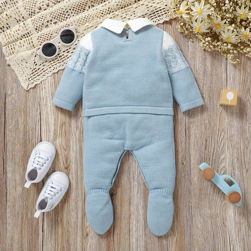 Top view of the Baby Corey Knit Footed Romper in sky blue, laid out on a wooden surface, showcasing its stylish design.