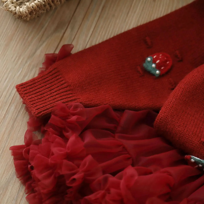 Detail shot of the flouncy tulle skirt from the Strawberry Girls Knit Sweater and Tulle Skirt - Deep Red, showcasing its fun and fluffy texture.