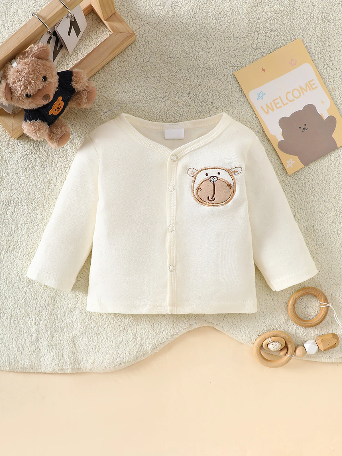 Little Bear beige 8-piece newborn romper set, 100% cotton, bear applique cardigan with front snaps; soft newborn wear.