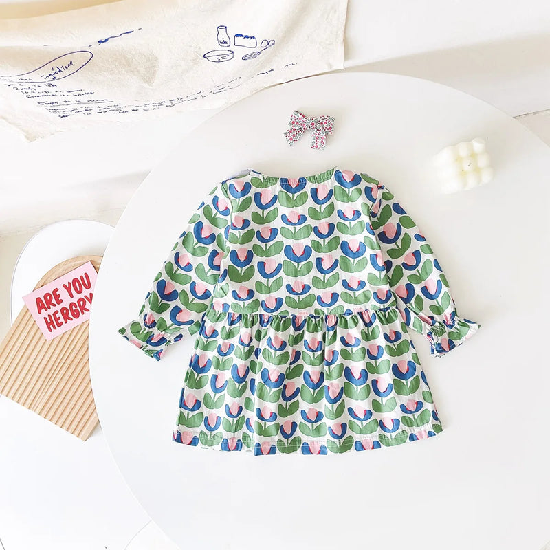 Back view of the "Mariella" Floral Print Peter Pan Collar Dress, highlighting the beautiful green floral print and gathered skirt.