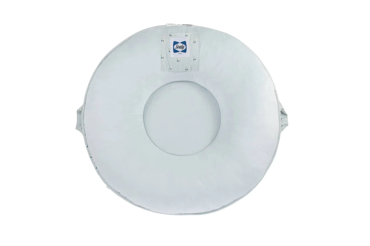 White Sealy floor cushion made of soft fabric with handles on sides for easy carrying