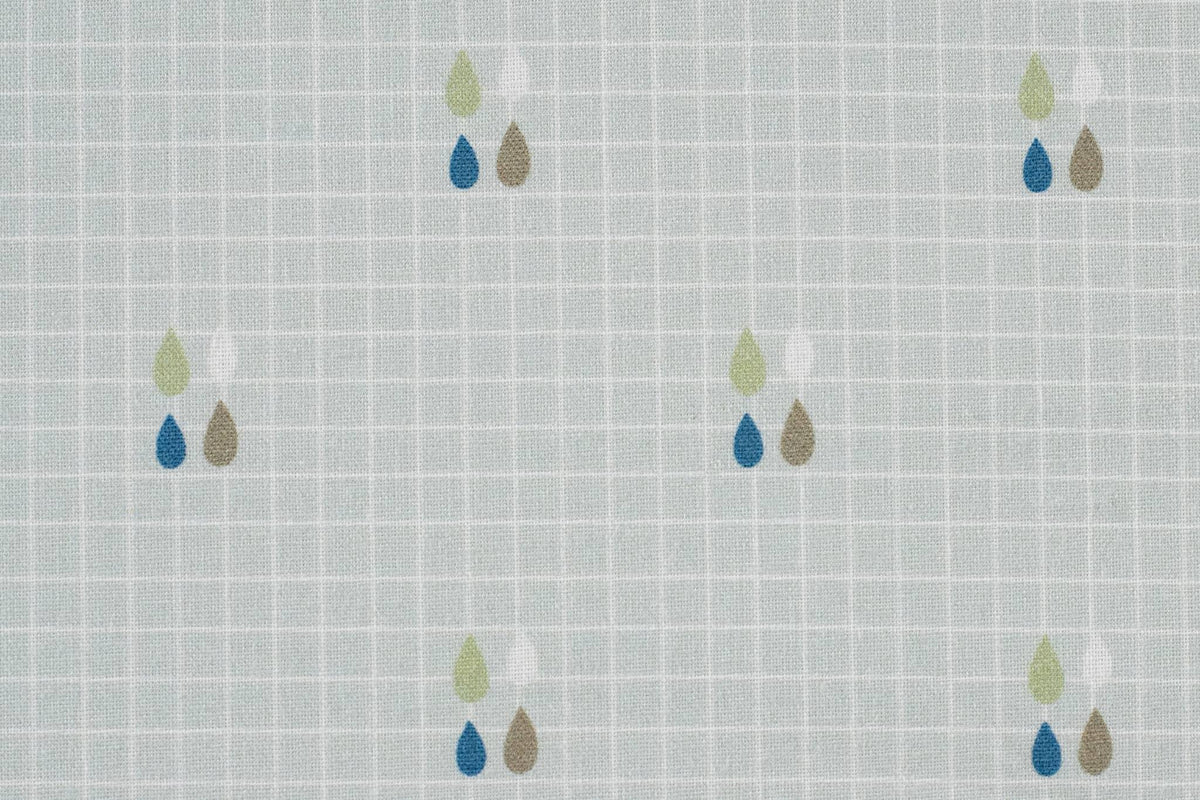 Light gray cotton Sealy floor cushion with subtle grid pattern and small colored teardrop designs