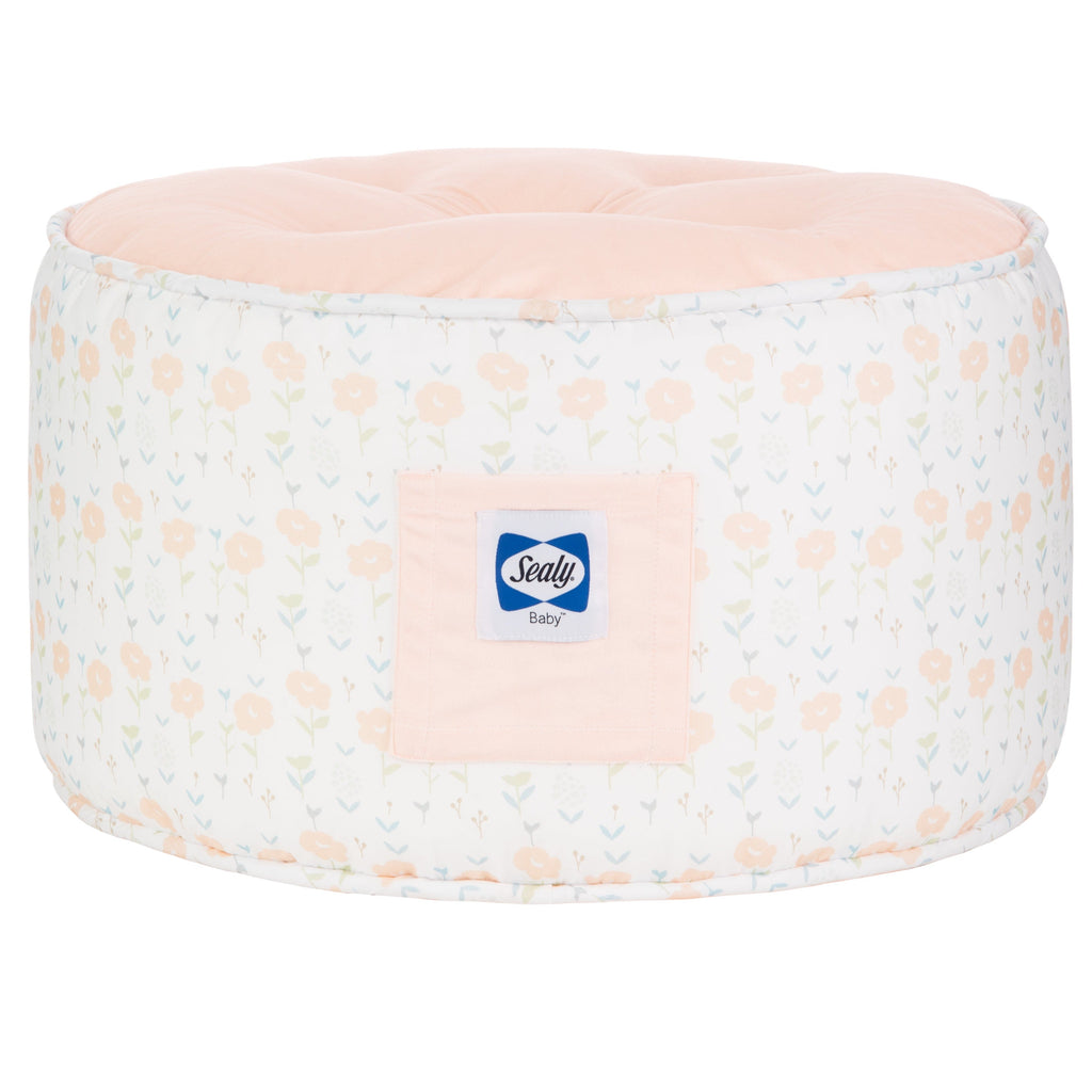 Sealy Pouf - Coral & Blossoms, featuring a cozy round design with a soft pink top and floral pattern, perfect for toddlers' playroom or nursery.