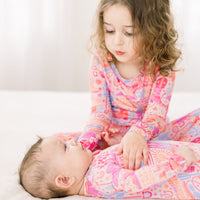 The Second-Skin 2-Piece Long Sleeve Pajama Saddle Up: girl in colorful cowgirl-print pajama set, cuddling with adult
