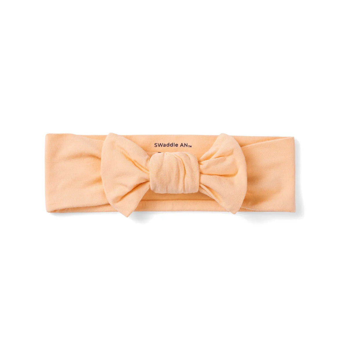 Peach fuzz baby bow headband with soft knot center and black SwaddleAn text on white background