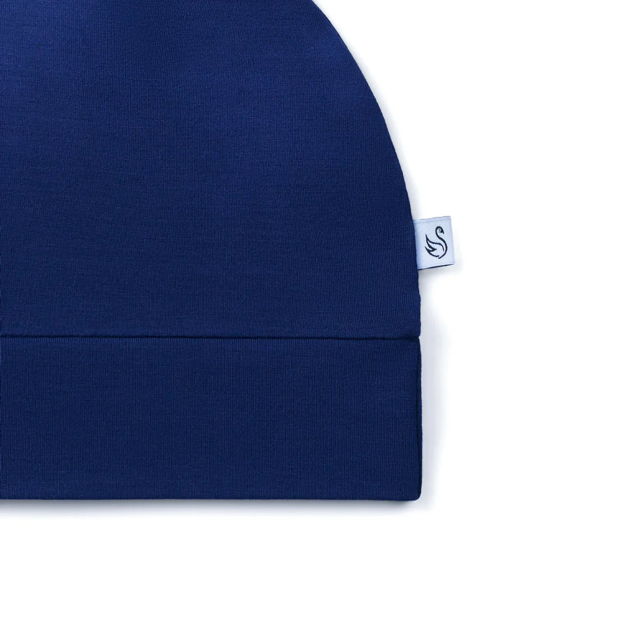 Side view of navy blue hat showing folded hem and swan logo tag