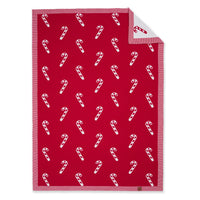 Red and white candy cane jacquard baby blanket flat lay with folded corner showing reverse side