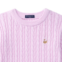 Close-up of lilac cable knit texture, blue neck label reading SWaddle AN, and gold swan embroidery