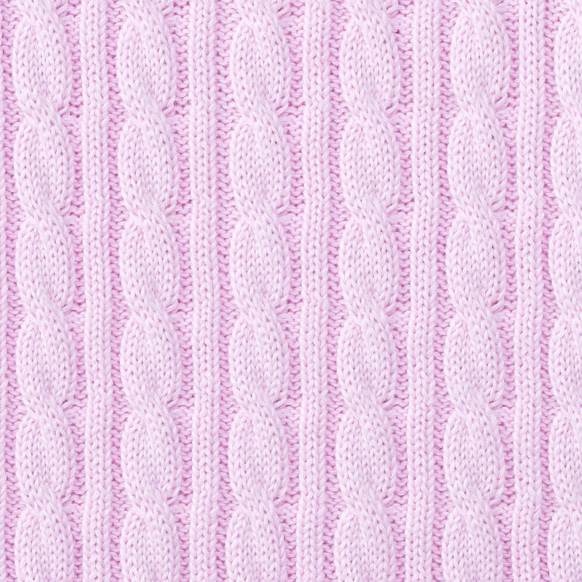 Macro shot of soft pink cotton yarn showing intricate raised vertical cable knit weave design