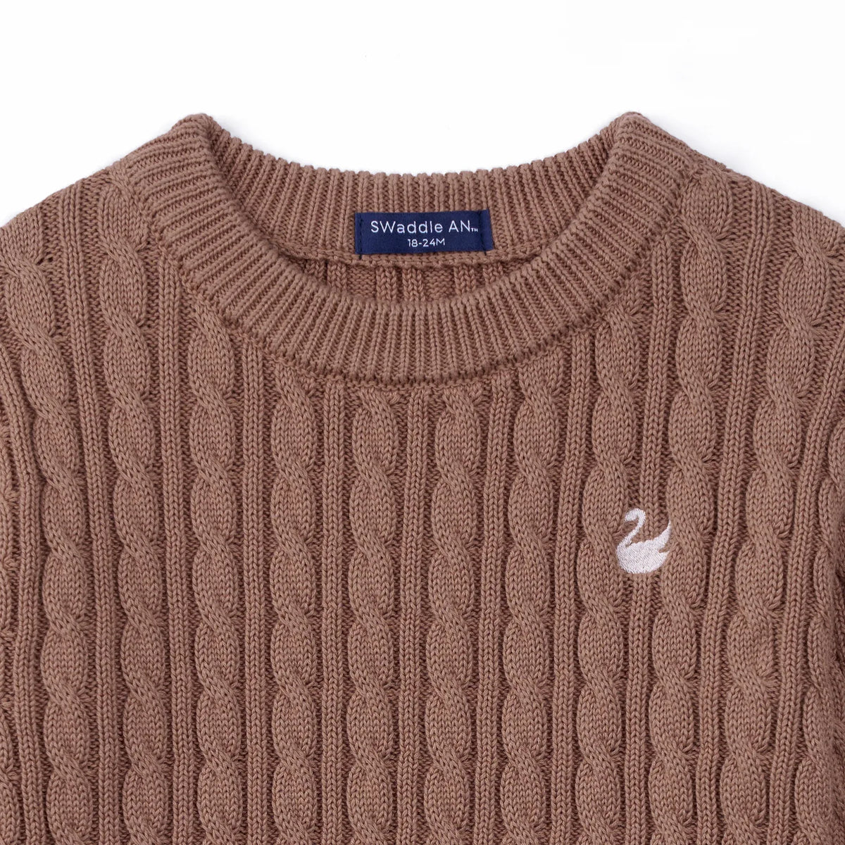 Close-up of mocha cotton sweater neckline showing navy size tag and white swan logo detail