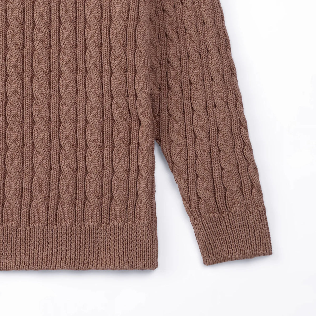 Detail shot of mocha baby sweater sleeve junction and consistent cable knit pattern continuity