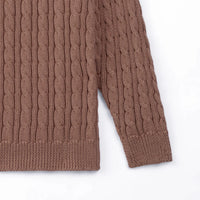 Detail shot of mocha baby sweater sleeve junction and consistent cable knit pattern continuity