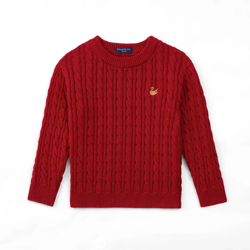 Flat lay of red cable knit baby sweater with ribbed crew neck, cuffs, and gold swan logo on chest