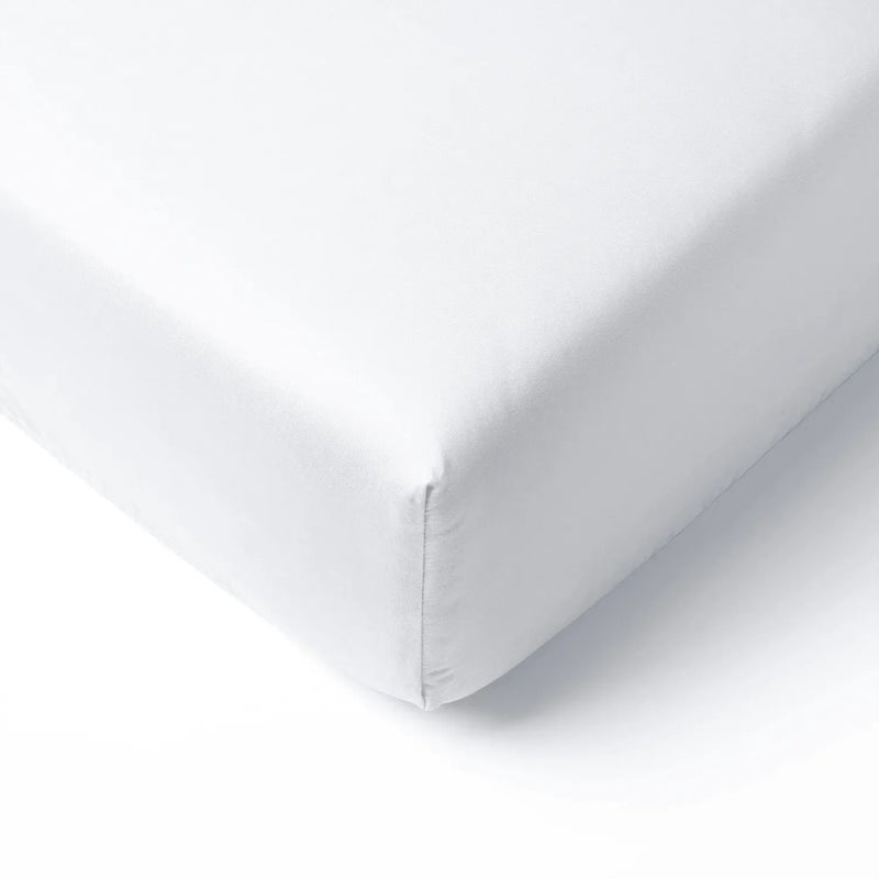 White bamboo crib sheet corner with smooth texture and precise elastic stitching