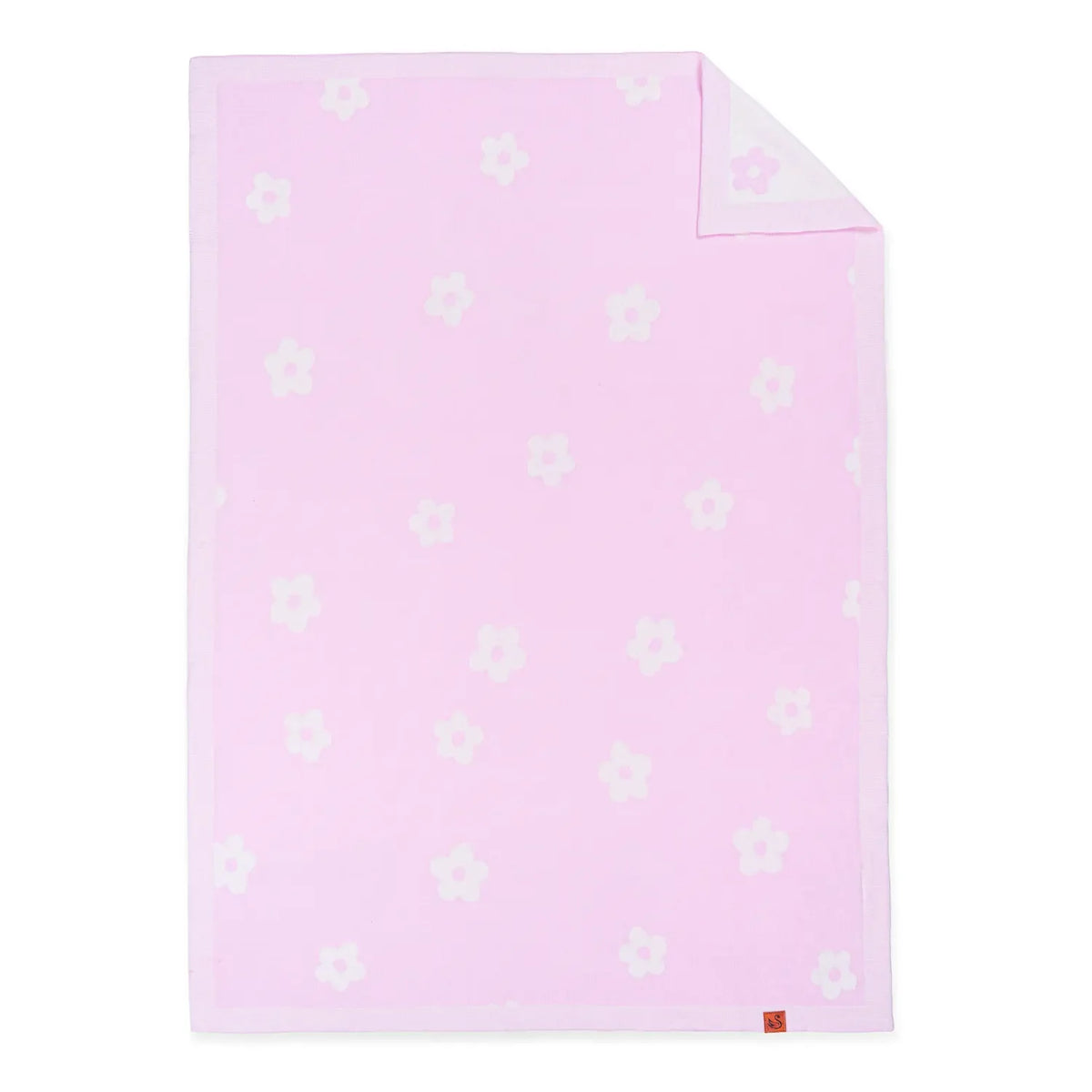Flat-lay of rectangular pink daisy jacquard knit baby blanket showing folded corner, reverse side texture, and orange size
