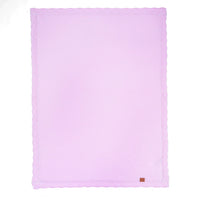 Flat lilac waffle-knit blanket showing lace edging and corner leather tag