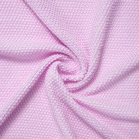 Extreme close-up of draped lilac fabric emphasizing waffle-knit weave pattern
