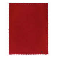 Unfolded red garter stitch blanket showing rectangular shape, lace edging, and corner tag