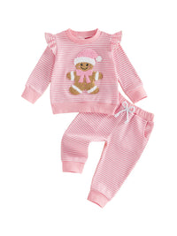 Pink and white striped waffle knit 2-piece set for girls featuring a gingerbread baby applique on the long sleeve ruffle pullover and matching pants.