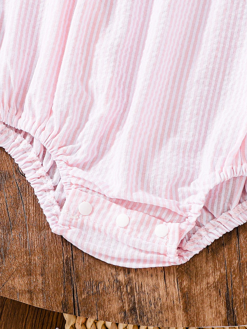 Snap closure detail of the Birthday Girl Romper, designed for easy diaper changes, with a soft cotton material ideal for active children.