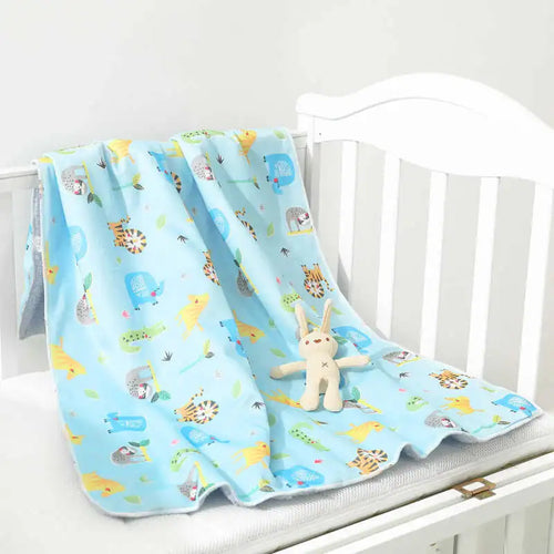 Lightweight ultra-soft kids' micro-plush reversible blanket in four colorful animal prints, blue with tiger motifs.
