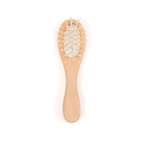 Wooden baby brush with soft bristles and rounded handle for gentle toddler grooming