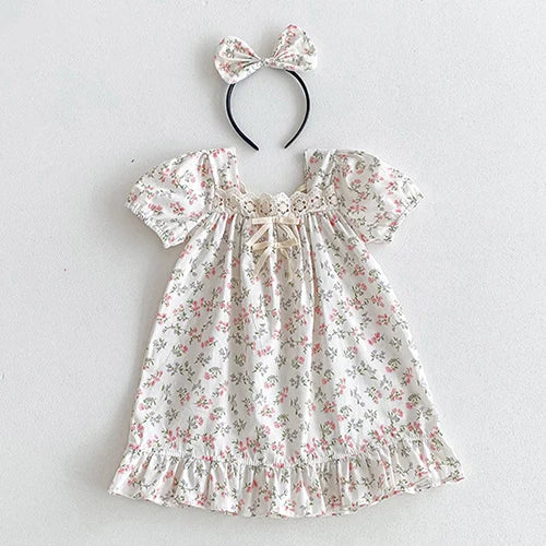 Vintage Outfits designed for little girls, displaying a charming floral dress with a bow headband, suitable for special events.