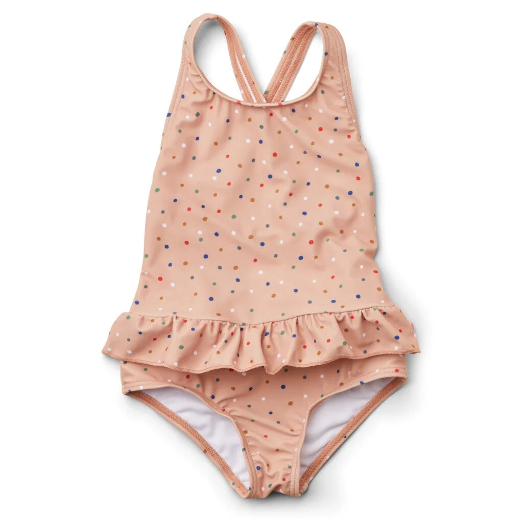 Frilly Prints sun-protective one-piece swimsuit for girls with multicolor dots, crisscross back, and a ruffled hem.