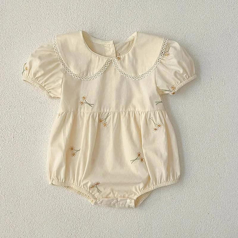 Cream embroidered baby bubble romper with puff sleeves and a lace-trimmed collar for infants